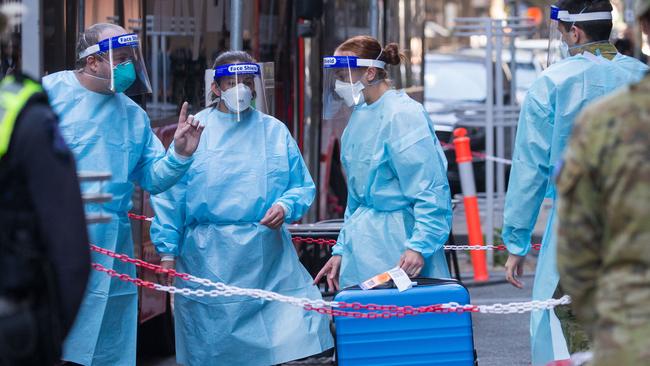 Quarantine staff at Melbourne Airport greet the first arrivals as Victoria resumed international flights on Thursday. Picture: Paul Jeffers