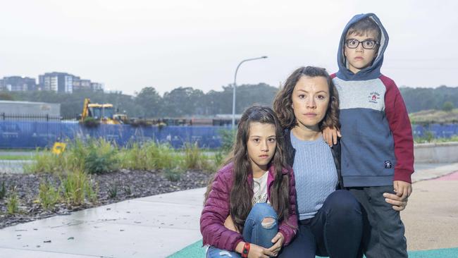 Amela Lakicevic with children Leila and Thomas. The family was told there would be a local school in the area, but say they’re still waiting for it to be built. Picture: Matthew Vasilescu