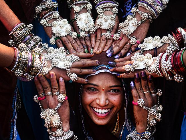 EMBARGO 9PM WEDNESDAY NOVEMBER 18TH © Sanghamitra Sarkar, India, Entry, Open, Smile, 2016 Sony World Photography Awards Tribal women of Gujrat in India wearing traditional silver ornaments and blessing a newly married girl.