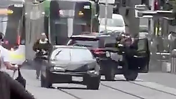 The car gets away from police in the Bourke Street Mall.