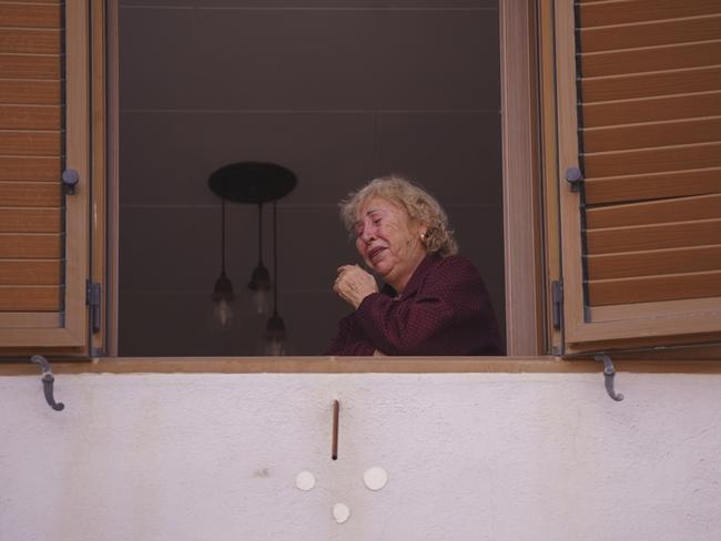 A woman cries by a window after floods in Paiporta, near Valencia, Spain. Picture: AP