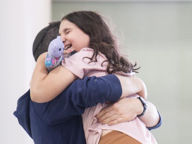 Heartwarming scenes at Sydney Airport after the repatriation flight landed. Picture: NCA NewsWIRE / Monique Harmer