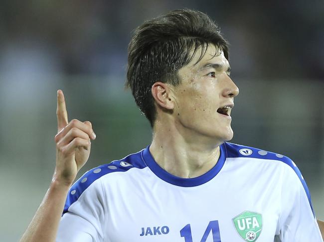 Uzbekistan's Eldor Shomurodov, centre, celebrates after scoring his side's opening goal during the AFC Asian Cup group F soccer match between Japan and Uzbekistan at Khalifa bin Zayed Stadium in Al Ain, United Arab Emirates, Thursday, Jan. 17, 2019. (AP Photo/Kamran Jebreili)