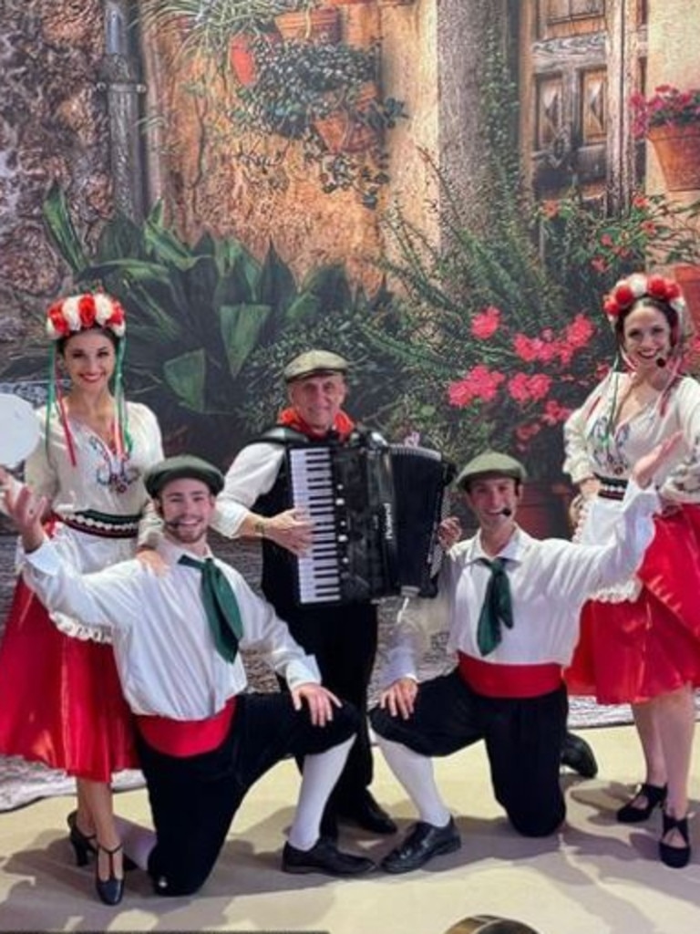 A troupe of performers danced and played the accordion.