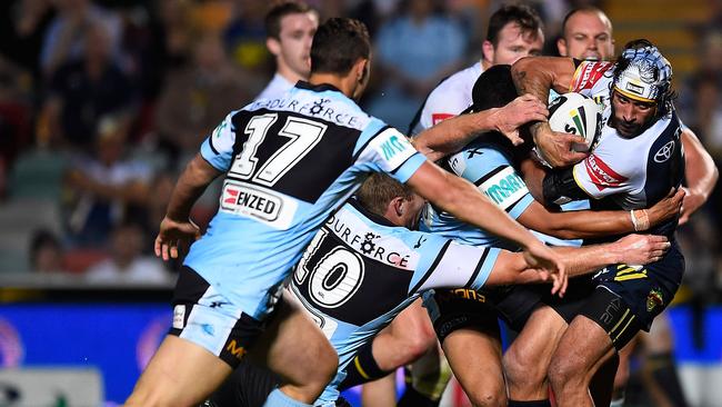 TOWNSVILLE, AUSTRALIA - SEPTEMBER 01: Johnathan Thurston of the Cowboys makes a break through the Sharks defence on his way to score a try during the round 25 NRL match between the North Queensland Cowboys and the Cronulla Sharks at 1300SMILES Stadium on September 1, 2014 in Townsville, Australia. (Photo by Ian Hitchcock/Getty Images)