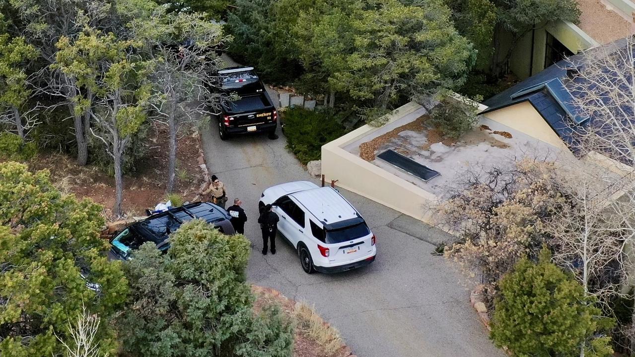 Law enforcement officials outside the home of actor Gene Hackman and his wife Betsy Arakawa who were found dead along with one of their dogs. Picture: Roberto Rosales / AP