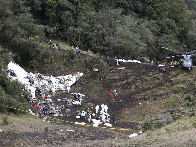 Rescue workers place the bodies of victims of an aeroplane crash into a waiting helicopter, in La Union, near Medellin, Colombia. Picture: AP