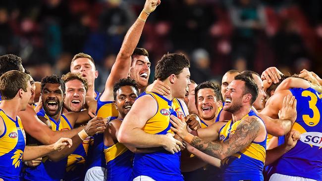 Jeremy McGovern of the Eagles celebrates with his team mates after kicking the winning goal. Picture: Getty