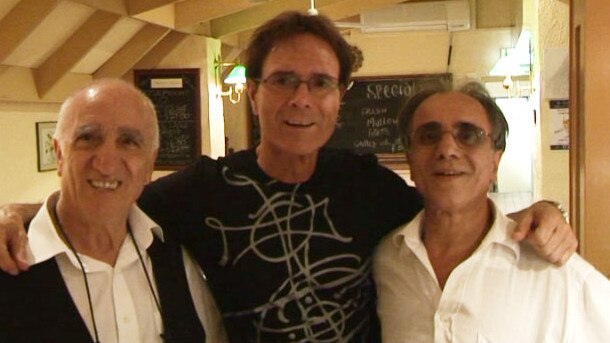 Sir Cliff Richard with staff members Nat and Joe at La Trattoria restaurant in Adelaide.