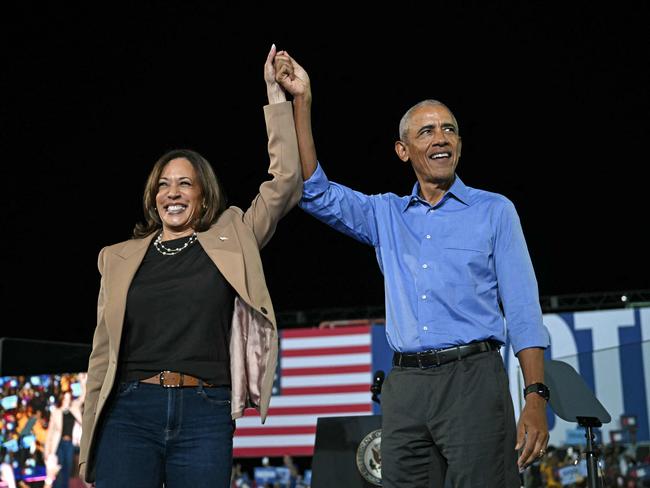 Former US President Barack Obama holds hands with US Vice President and Democratic presidential candidate Kamala Harris during a campaign rally at the James R Hallford Stadium in Clarkston, Georgia. Picture: AFP