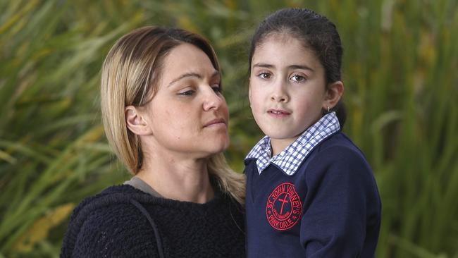 Tanya Rosenquist with her daughter, Maddie, 7, who survived a tree branch falling on her at school. Picture: Wayne Taylor