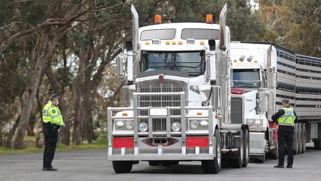 Police speak to a truck driver on the Victorian border at Bordertown last month. Picture: Tait Schmaal