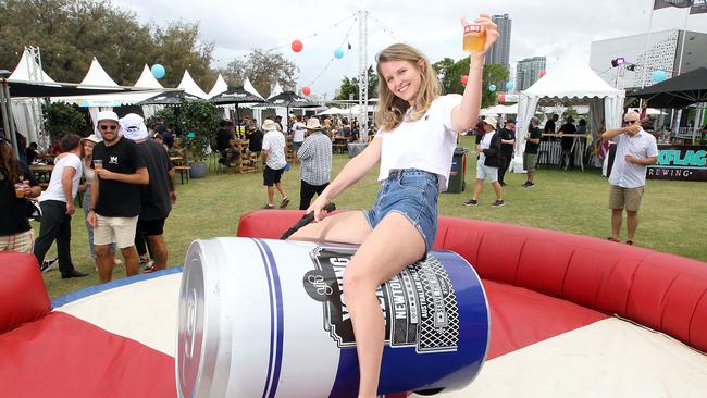 A beer festival in Queensland, with Ellen McDonald riding a giant can of Sydney beer Young Henry’s . Picture: Richard Gosling