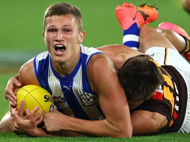 MELBOURNE, AUSTRALIA - APRIL 21: Zane Duursma of the Kangaroos attempts to handballs whilst being tackled during the round six AFL match between North Melbourne Kangaroos and Hawthorn Hawks at Marvel Stadium, on April 21, 2024, in Melbourne, Australia. (Photo by Quinn Rooney/Getty Images)