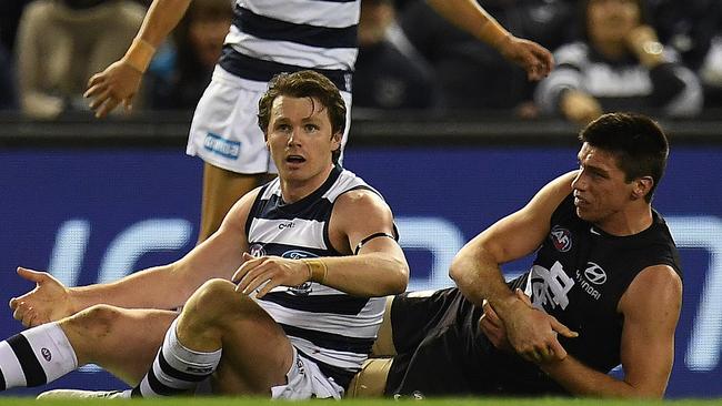 Patrick Dangerfield of the Cats (front left) and Matthew Kreuzer of the Blues (right) are seen after Dangerfield executed a tackled on the ruckman during the Round 19 AFL match between the Carlton Blues and the Geelong Cats at Etihad Stadium in Melbourne, Saturday, July 29, 2017. (AAP Image/Julian Smith) NO ARCHIVING, EDITORIAL USE ONLY