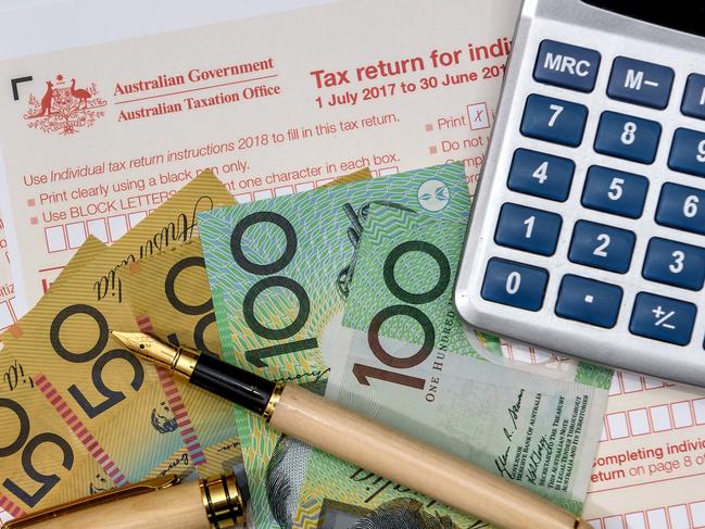 Australian dollars with calculator and tax form, tax time generic money, forms, taxation