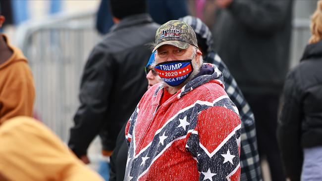 Attendees wait for the arrival of U.S. President Donald Trump during a campaign rally on October 17, 2020 in Muskegon, Michigan.