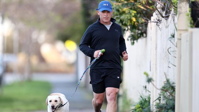 Alastair Clarkson out for an early morning run with his dog Beaver in Brighton this morning. Picture: Michael Klein