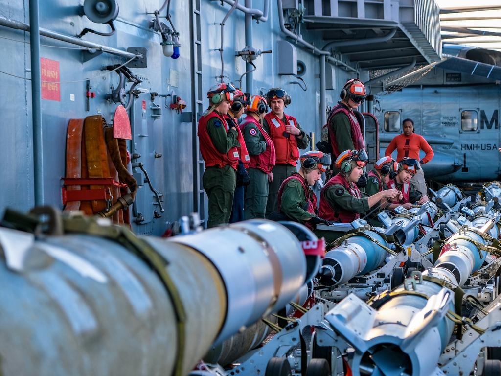 U.S. Marine Corps Aviation Ordnance Technicians with Marine Medium Tiltrotor Squadron 265 (Reinforced), 31st Marine Expeditionary Unit (MEU), inspect and prepare munitions to be loaded onto F-35B Lightning IIÃ¢â&#130;¬â&#132;¢s aboard the USS America (LHA 6), during Talisman Sabre on July 17, 2021. The F-35B Lightning IIÃ¢â&#130;¬â&#132;¢s fifth generation strike fighter capabilities bring more lethality and flexibility to combat commanders than any other aircraft platform. Australian and U.S. forces combine biannually for Talisman Sabre, a month-long multi-domain exercise that strengthens allied and partner capabilities to respond to the full range of Indo-Pacific security concerns. The 31st MEU is operating aboard ships of America Expeditionary Strike Group in the 7th fleet area of operations to enhance interoperability with allies and partners and serve as a ready response force to defend peace and stability in the Indo-Pacific region. (U.S. Marine Corps photo by Staff Sgt. John Tetrault)