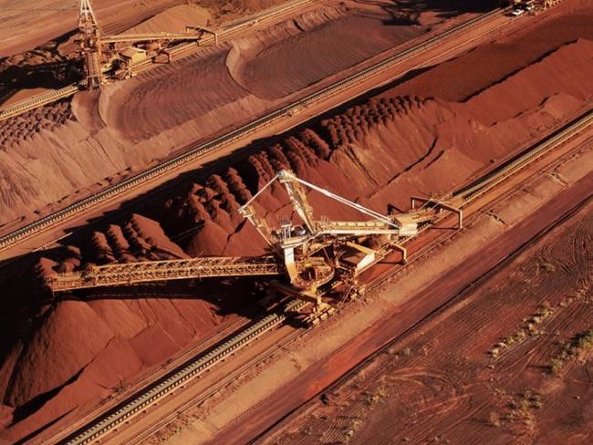 An undated handout photo released by BHP Billiton shows iron ore being stockpiled for export at Port Hedland in Western Australia. BHP Billiton reported an annual net loss of USD 6.39 billion on August 16, 2016, its worst-ever result, as the impact of a fatal mine dam disaster in Brazil and weak commodity prices hit the world's biggest miner. / AFP PHOTO / bhp / bhp / ----EDITORS NOTE ----RESTRICTED TO EDITORIAL USE MANDATORY CREDIT 