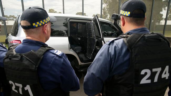 Corrections officers inspect a new supermax prison trucks for transfer of high risk inmates at the Mary Wade Correctional Centre in Lidcombe.