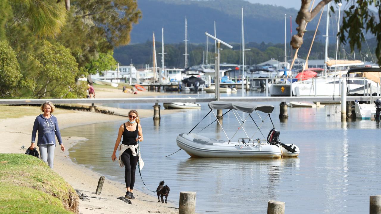 Residents and tourists exercise along the Noosa River.