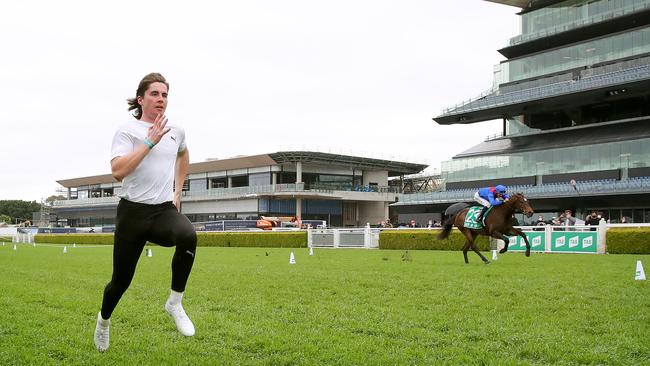 Olympic 100m sprinter Rohan Browning races champion jockey Hugh Bowman on-board Impossible Hero. Picture: Toby Zerna