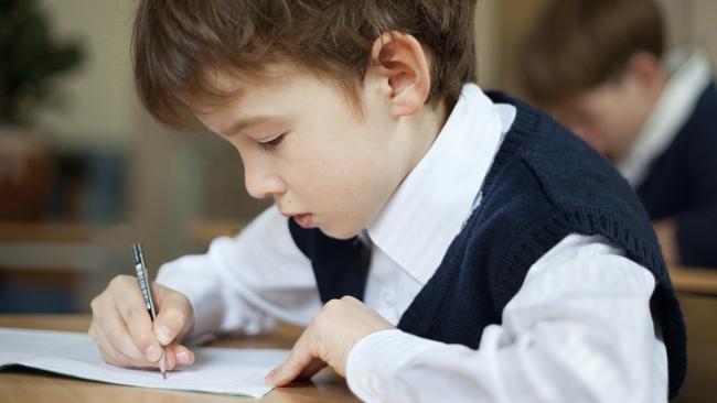 Diligent student sitting at desk, classroomtoddler pre-school, prep school, education generic, thinkstock, private school