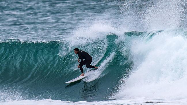 Joel Parkinson surfs in the wild seas at Kirra Beach on Friday. Picture: Nigel Hallett