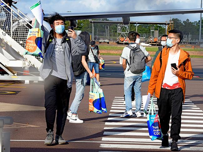 Foreign students disembark from an international flight at Darwin Airport on Monday. Picture: AFP