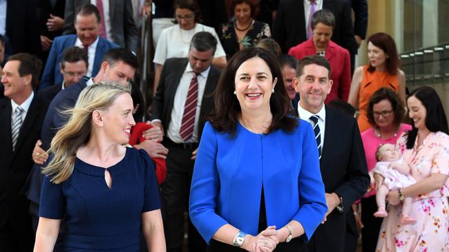 Queensland Premier Annastacia Palaszczuk (right) and Innovation, Tourism and Commonwealth Games Minister Kate Jones walk away after a posing for a group photo during the first Labor caucus meeting of the 56th Queensland Parliament at Parliament House in Brisbane, Monday, December 11, 2017. Ms Palaszczuk's Labor will govern with a slim majority of forty eight seats. (AAP Image/Dan Peled) NO ARCHIVING