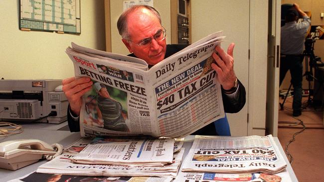 John Howard reading Daily Telegraph newspaper covering announcement of GST tax package in 1998.