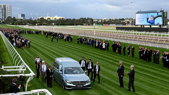 Mourners form a guard of honour for Dean Holland.