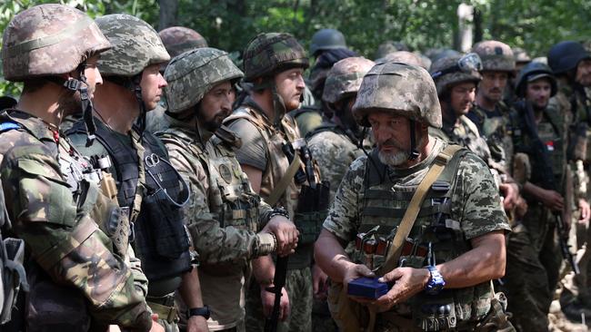 A Ukrainian soldier holds an awards during a ceremony at a position along the front line in the Donetsk region last week. Picture: AFP