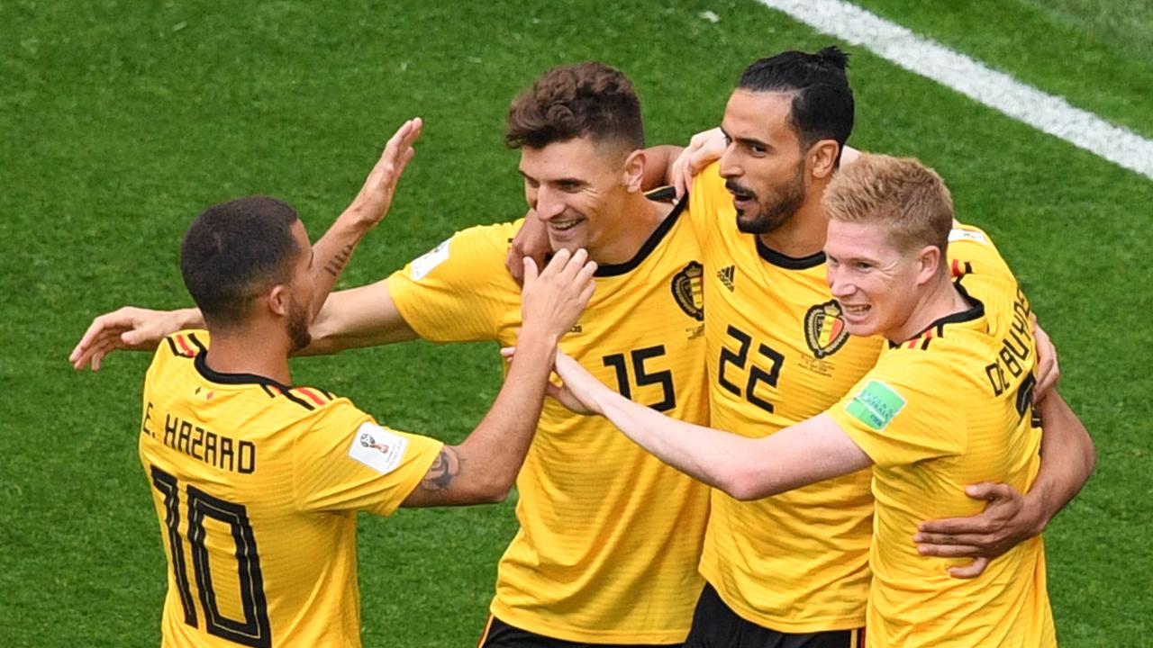 Belgium's defender Thomas Meunier (2L) is congratulated by his teammates after scoring.
