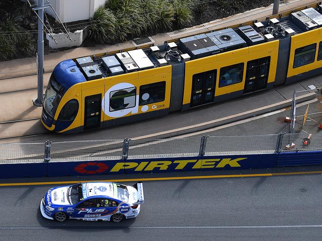 V8 Supercars driver Taz Douglas passes a G:link tram during a practice session at the 2017 Gold Coast 600. The introduction of light rail helped spread the spoils of race weekend further along the Coast. Picture: AAP Image/Dave Hunt.