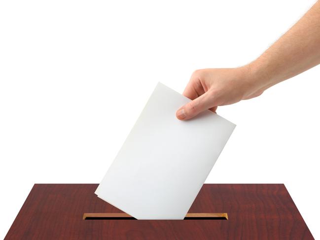 Thinkstock generic image of hand voting, putting piece of white paper into ballot box.