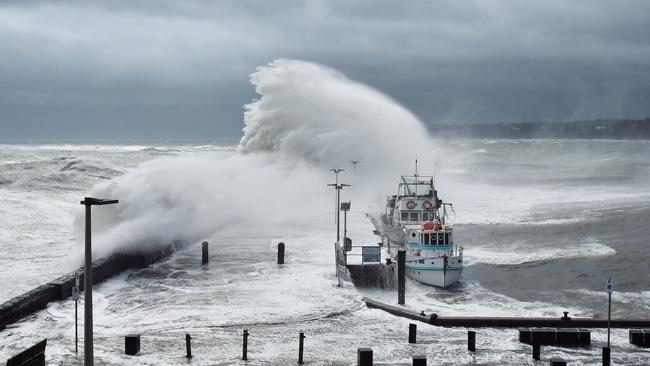 Huge waves smash the Mornington pier as fierce gale winds move across the bay. Picture: Adam Richmond