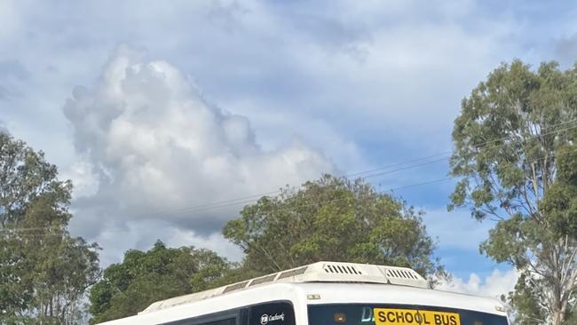 A Polleys Bus waiting outside James Nash State High School to pick up students.