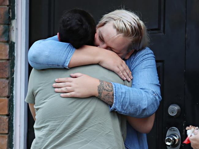 Bray Park neighbour Lisa Livingstone-Kameta comforts a friend of Dion Dundy. Picture: Annette Dew