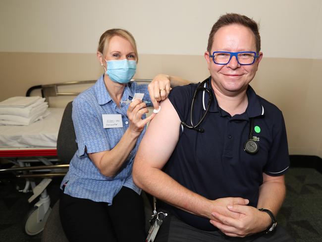 Nurse Alison Clancy gives infectious disease expert Associate Professor Paul Griffin his AstraZeneca vaccine at the Mater Hospital. Picture: Annette Dew