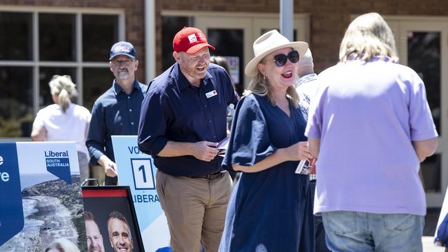 Labor Candidate Alex Dighton and Liberal Candidate Amanda Wilson speak to people voting in the Black by-election. Picture: Brett Hartwig