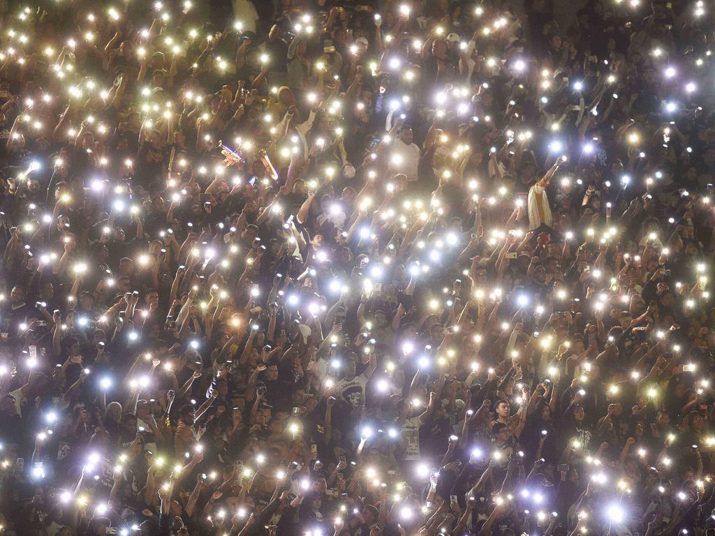 Fans cheer on their team by lighting up their cell phones during the Mexican Apertura 2023 match between Pumas and Guadalajara in Mexico City. Picture: Rodrigo Oropeza/AFP