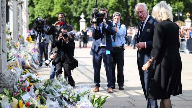 Britain's King Charles III and Britain's Camilla, Queen Consort view floral tributes upon their arrival Buckingham Palace. Picture: AFP.