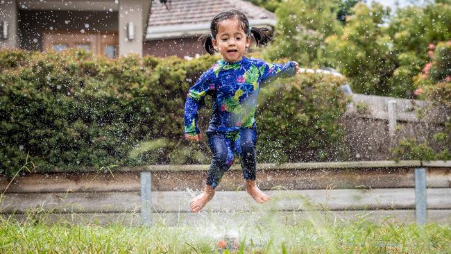 Ava, 2, cools off in the backyard of her home in Melbourne. Picture: Jake Nowakowski