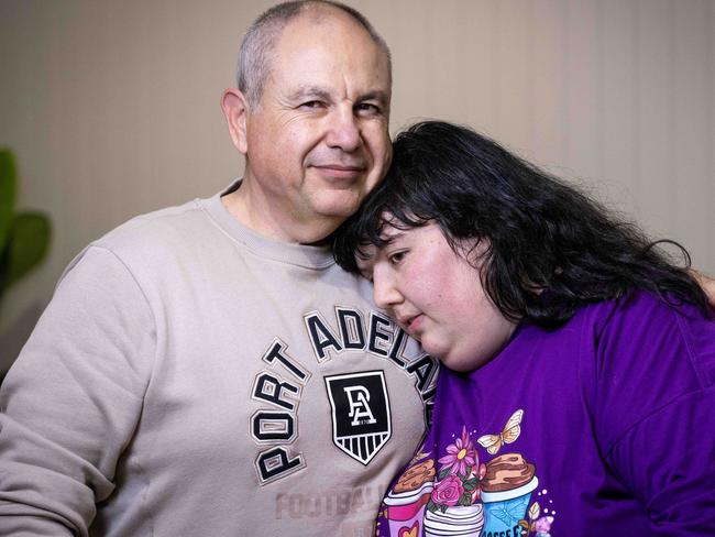 August 19, 2024: Georgia Kosteriadis with her dad Alex Kosteriadis at their home in seaton. They are on the verge of being evicted and bankruptcy after the NDIS cut two-thirds of their daughters funding against the advice of doctors. Picture: Kelly Barnes