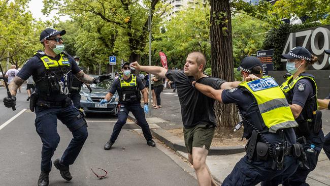 An anti-vaxxer protester clashes with police in Melbourne. Picture: Jake Nowakowski