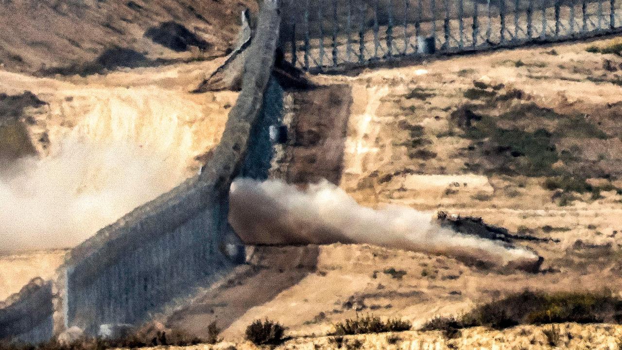 An Israeli army battle tank crosses a barbed wire fence at a position along the border with the Gaza Strip and southern Israel. Picture: AFP