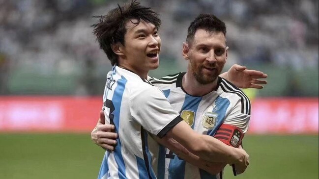 The fan hugs Messi before being removed by security.