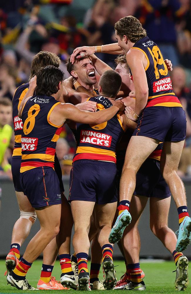 The Crows celebrate veteran Brodie Smith’s late goal. Picture: Sarah Reed/AFL Photos